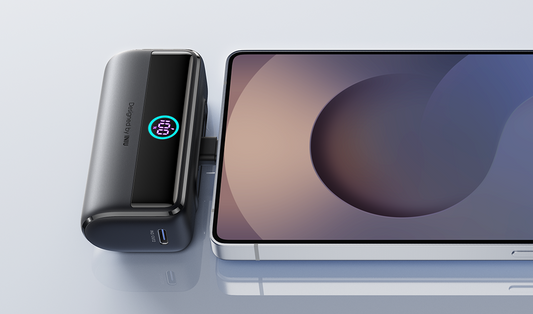 A compact power bank charging a phone via a built-in cable.