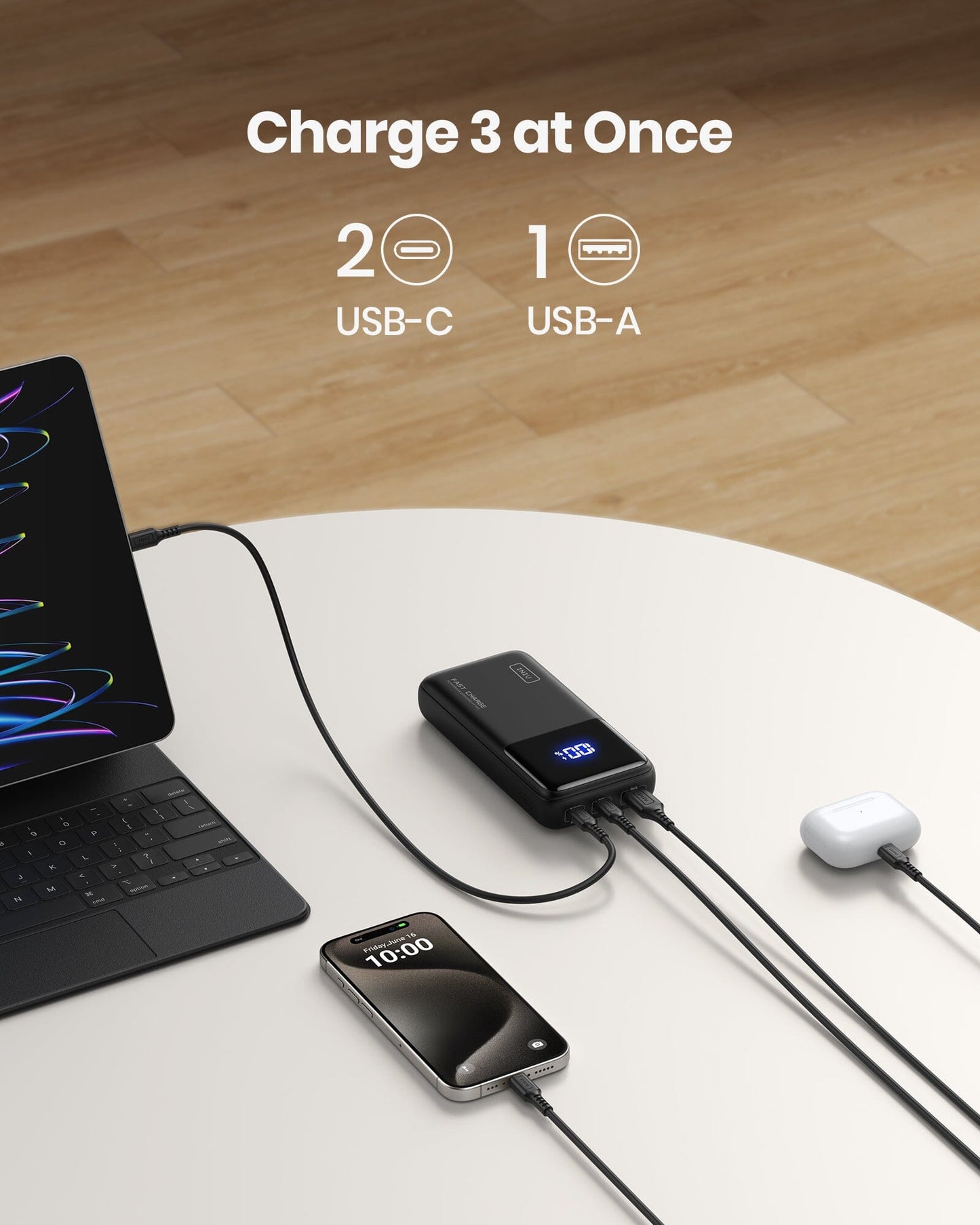 INIU B62 power bank charging three devices simultaneously: MacBook, iPhone, and AirPods. Features 2 USB-C and 1 USB-A port.